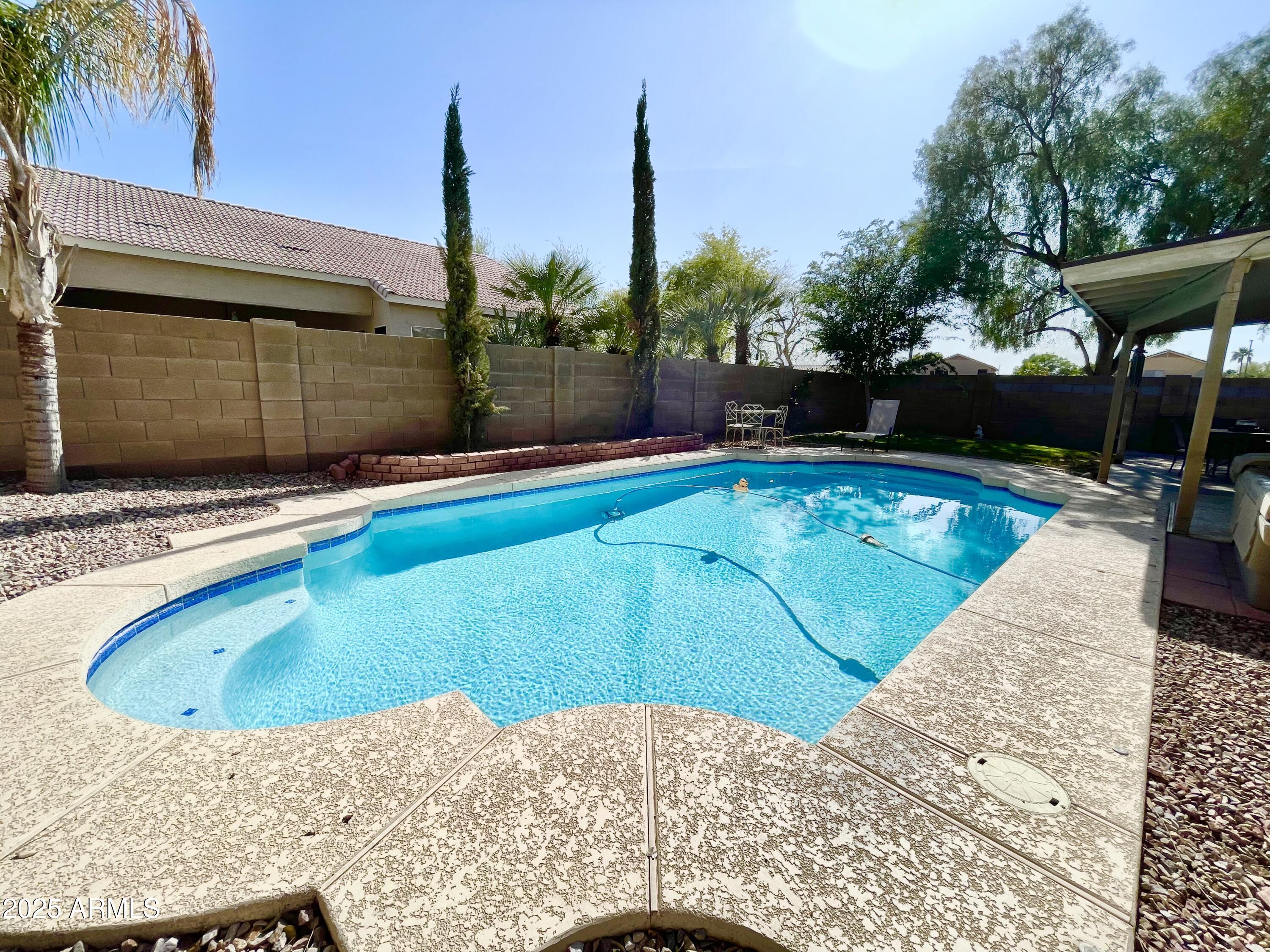 2735 East Harwell Road Gilbert, AZ 85234 - Photo 26 of 43 a view of a swimming pool with a patio