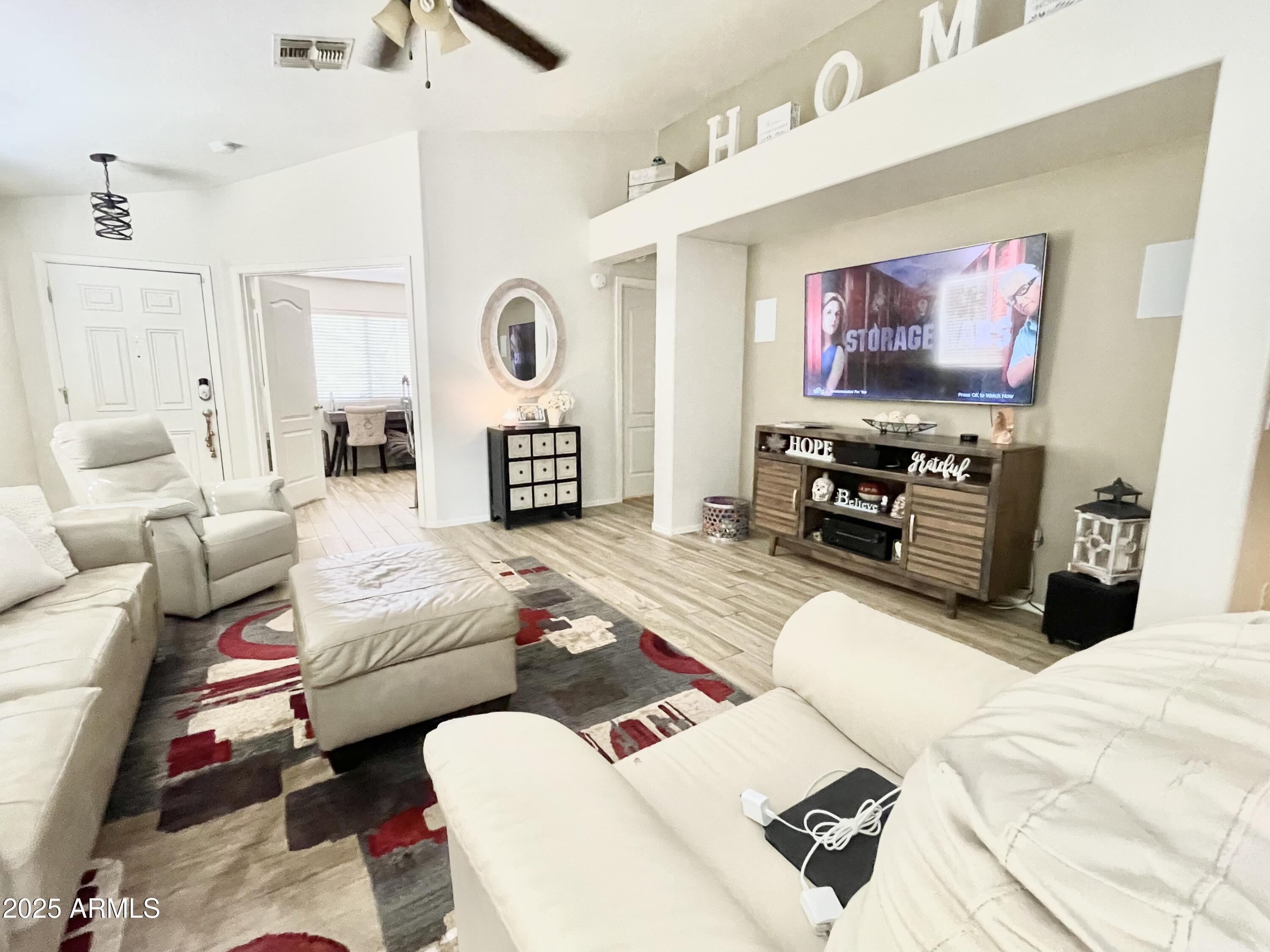 2735 East Harwell Road Gilbert, AZ 85234 - Photo 8 of 43 a living room with furniture and a flat screen tv
