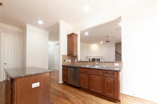 a large white kitchen with a sink stainless steel appliances and cabinets