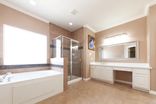 a spacious bathroom with a bathtub and a shower