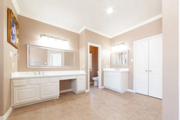 a view of a hallway with bathroom and a sink