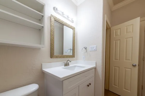 a bathroom with a sink a toilet and a mirror