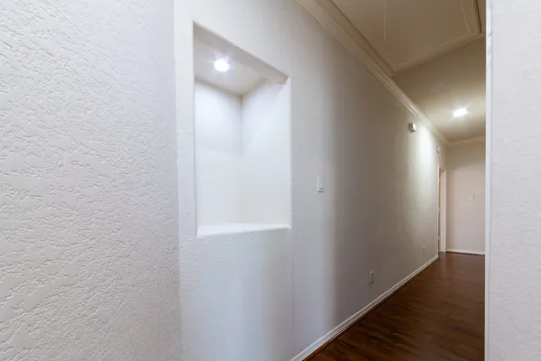 a view of hallway with wooden floor