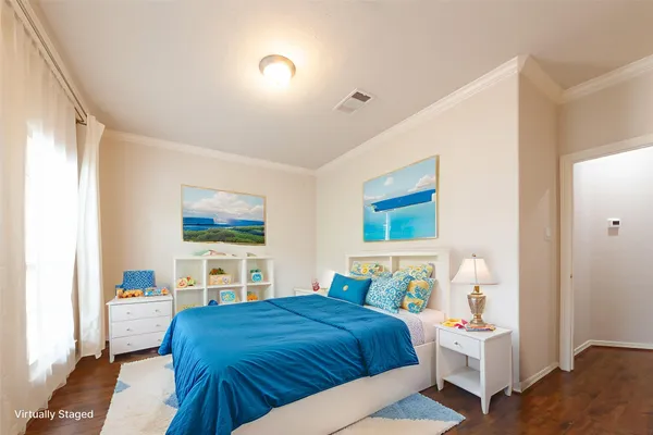a bedroom with a large bed and a tv