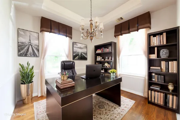 a living room with furniture lamps and wooden floor
