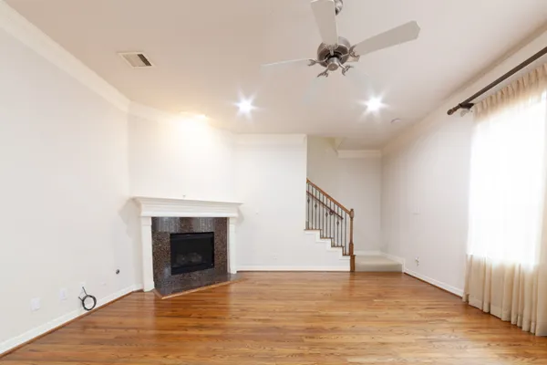 a view of an empty room with a fireplace and a window