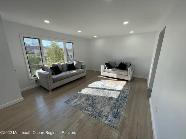 a bedroom with furniture and a large window