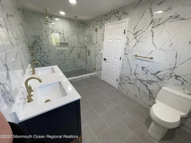 a bathroom with a sink toilet and shower