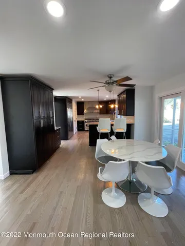 a living room with furniture and a dining table