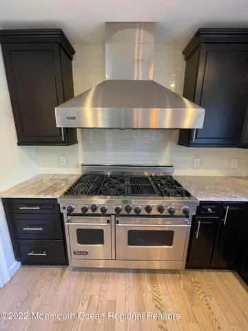 a stove top oven sitting inside of a kitchen