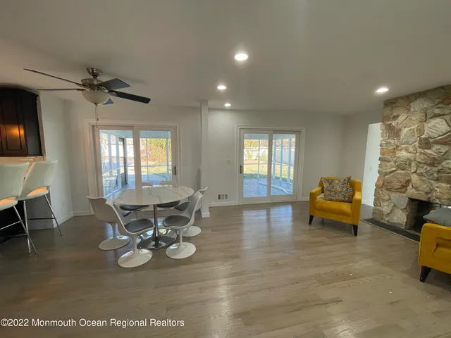 a view of dining room and livingroom with furniture wooden floor a chandelier
