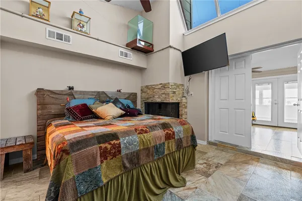 a bedroom with a bed and a flat screen tv