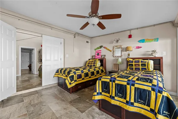 a bedroom with furniture and a ceiling fan