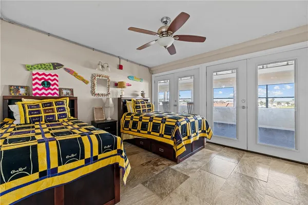 a bedroom with two beds and window