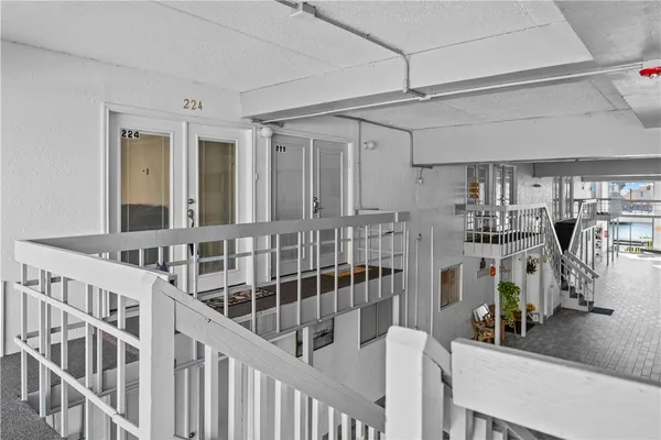 a view of a swimming pool with a living room and a bookshelf