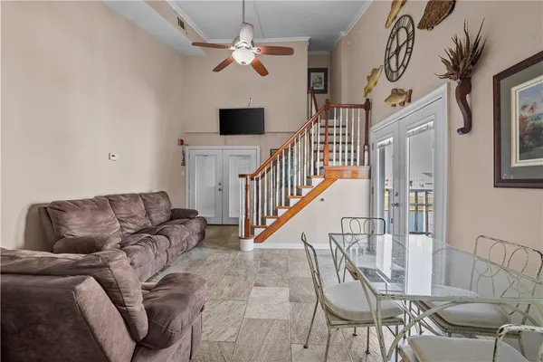 a living room with furniture and a chandelier