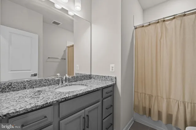 a bedroom with bed and balcony