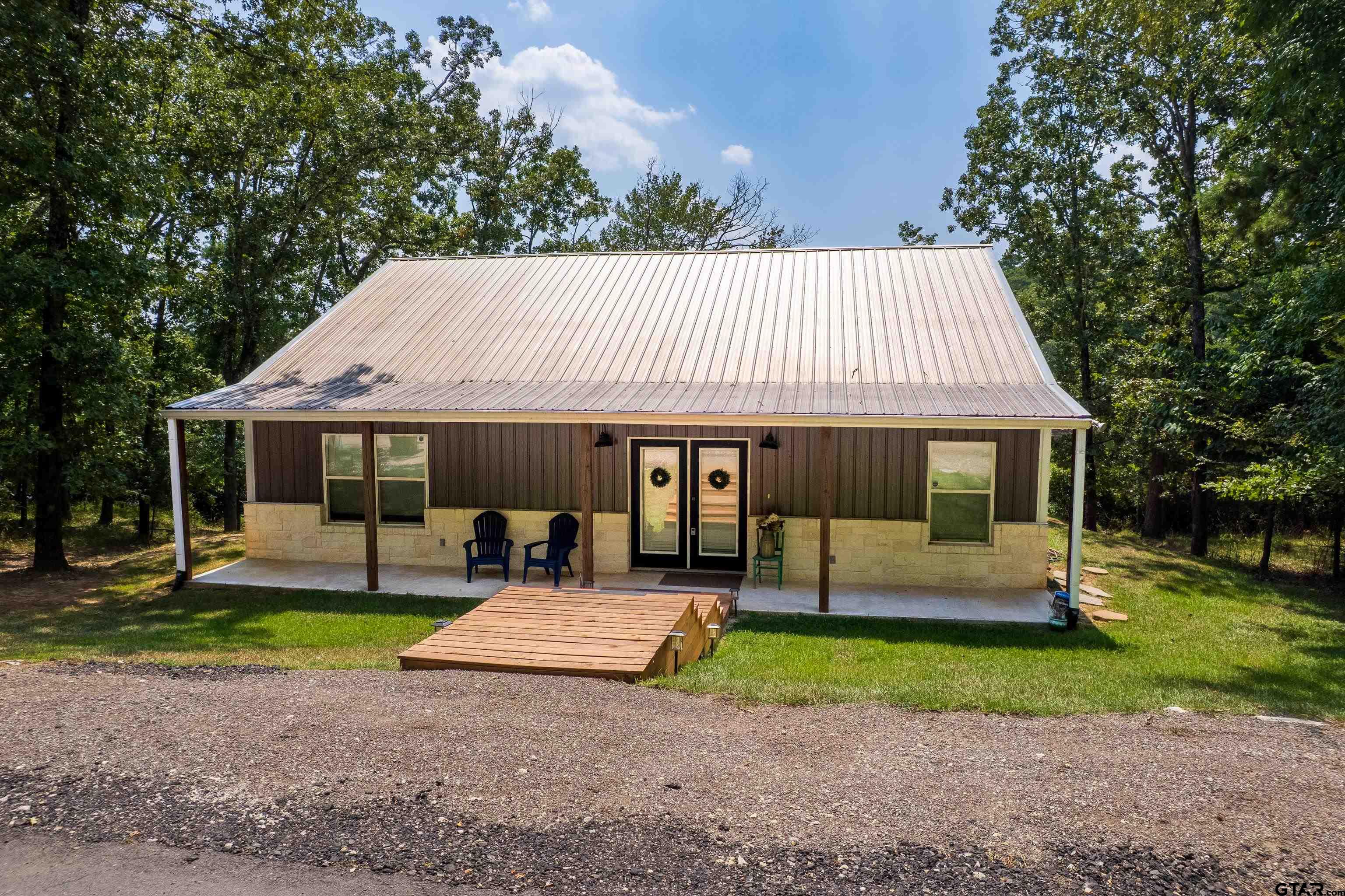 132 King George Road Scroggins, TX 75480 - Photo 4 of 35 a front view of a house with garden