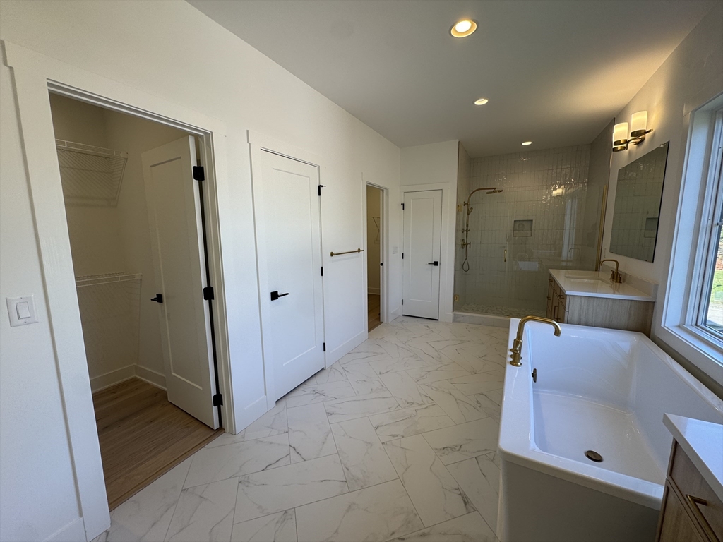 12 Old County Road, Unit 20 Hudson, MA 01749 - Photo 27 of 30 a bathroom with a tub sink and mirror