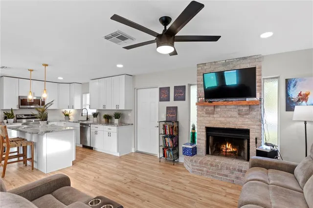 a bedroom with a bed a window and a painting on the wall
