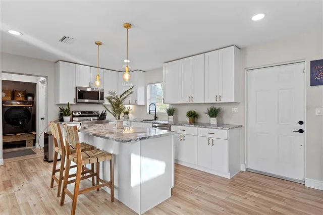 an aerial view of a house with garden space and street view