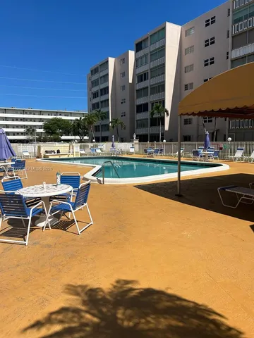 a view of a swimming pool with outdoor seating