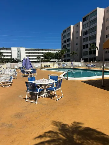 a view of a swimming pool with outdoor seating