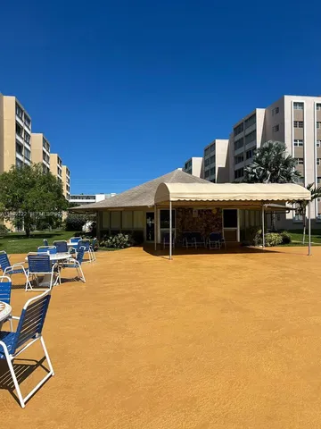 a view of a swimming pool with outdoor seating