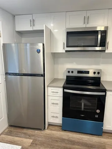 a kitchen with stainless steel appliances a stove microwave and a refrigerator