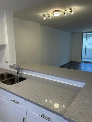 a kitchen with a sink and cabinets