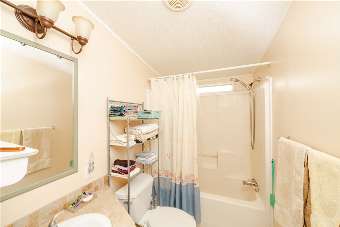 18488 Golf Course Avenue Wikieup, AZ 85360 - Photo 19 of 41 MAIN HOUSE: Guest bath featuring shower / bathtub combination with curtain, vanity, and a textured ceiling