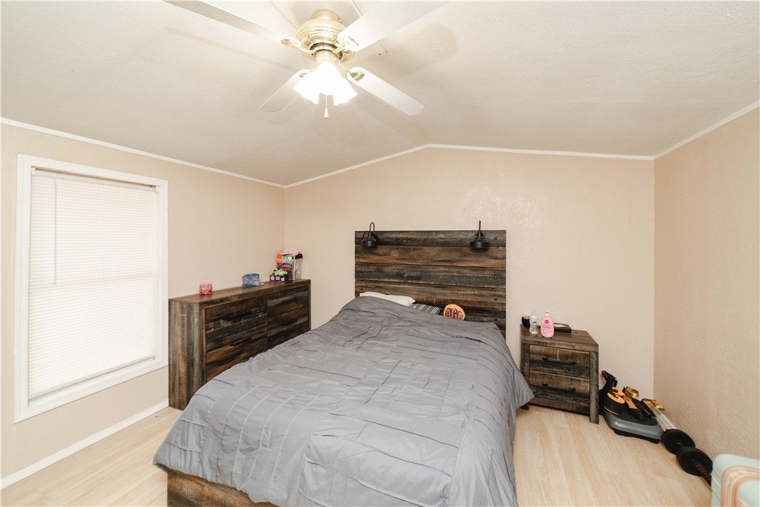 18488 Golf Course Avenue Wikieup, AZ 85360 - Photo 29 of 41 Guest house: Bedroom featuring light wood-style flooring, lofted ceiling, crown molding, and ceiling fan