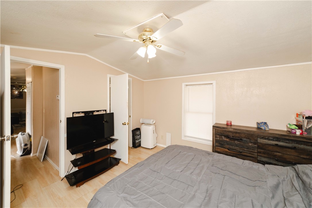 18488 Golf Course Avenue Wikieup, AZ 85360 - Photo 30 of 41 GUEST HOUSE: Bedroom featuring vaulted ceiling, light wood-style floors, and a ceiling fan