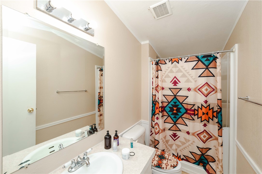 18488 Golf Course Avenue Wikieup, AZ 85360 - Photo 34 of 41 GUEST HOUSE: Full bath with a shower with shower curtain, vanity, and crown molding