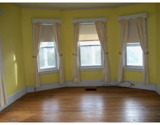 10 High Street Ayer, MA 01432 - Photo 5 of 8 an empty room with wooden floor and windows