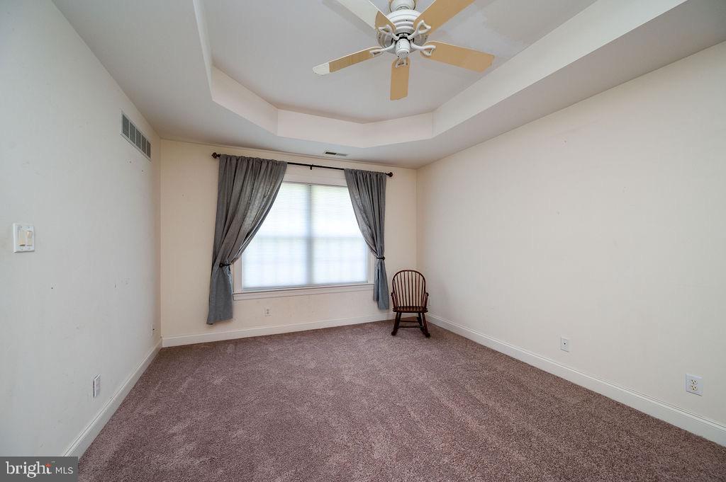 314 Charleston Lane Reading, PA 19610 - Photo 11 of 23 an empty room with a ceiling fan and window