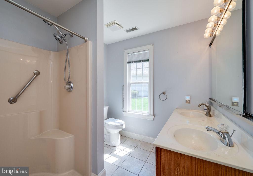 314 Charleston Lane Reading, PA 19610 - Photo 13 of 23 a bathroom with a sink toilet a shower and a mirror
