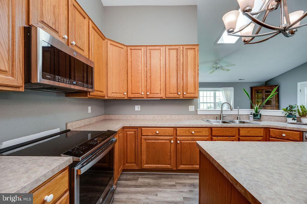 314 Charleston Lane Reading, PA 19610 - Photo 7 of 23 a kitchen with stainless steel appliances granite countertop a stove a sink and a microwave