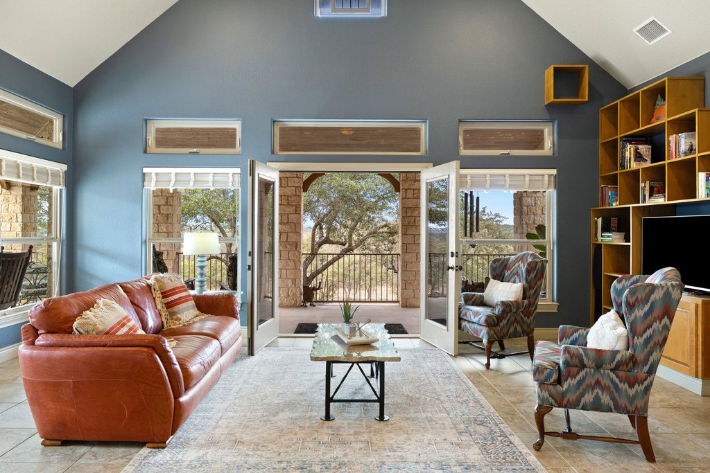 232 Crooked Oak Round Mountain, TX 78663 - Photo 7 of 40 Living area featuring high vaulted ceiling, french doors, and light tile patterned flooring