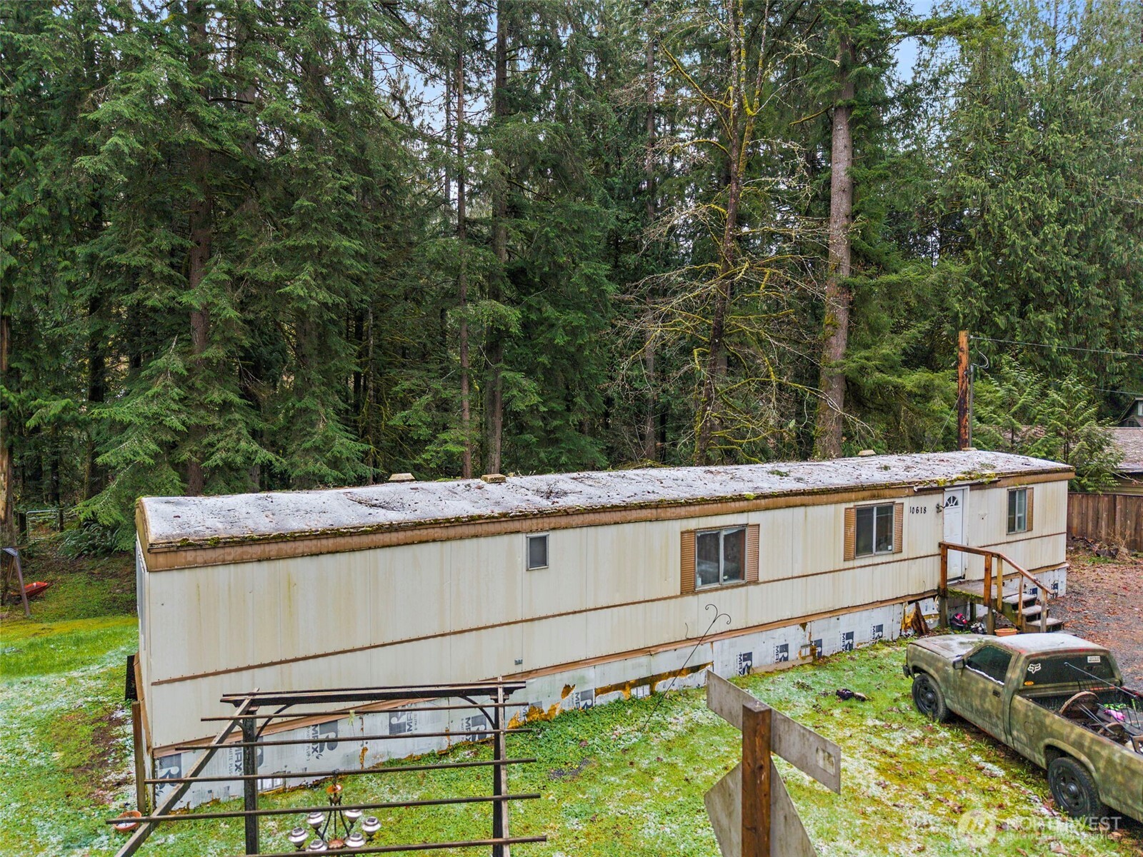 10618 Kelly Road Northeast Carnation, WA 98014 - Photo 3 of 16 a view of a house with a large window and wooden fence