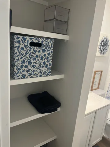 a bathroom with a sink mirror and toilet