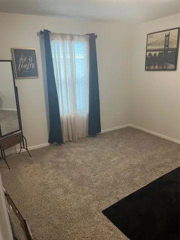 a bathroom with a toilet and a shower curtain