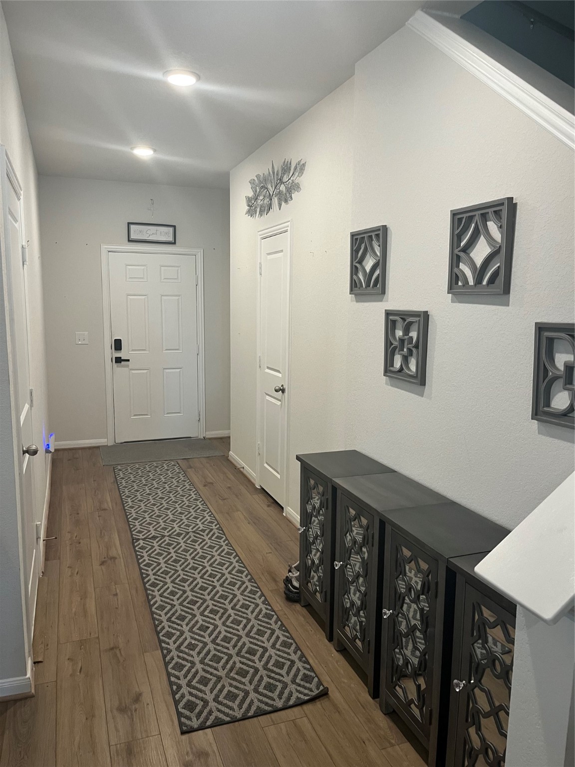 217 Lt. Rusty Jarrell, TX 76537 - Photo 7 of 28 a view of a hallway with wooden floor and bathroom