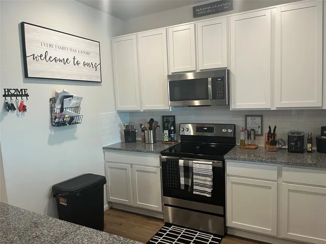 a kitchen with a refrigerator and cabinets