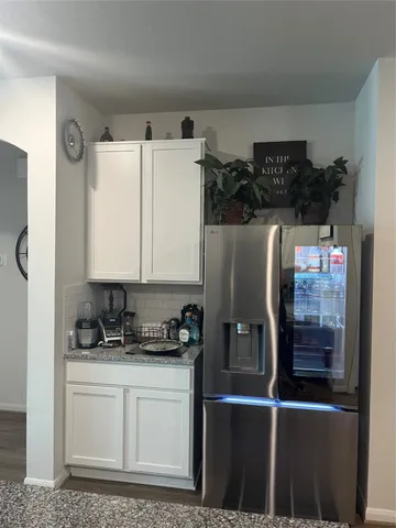 a living room with chairs and window