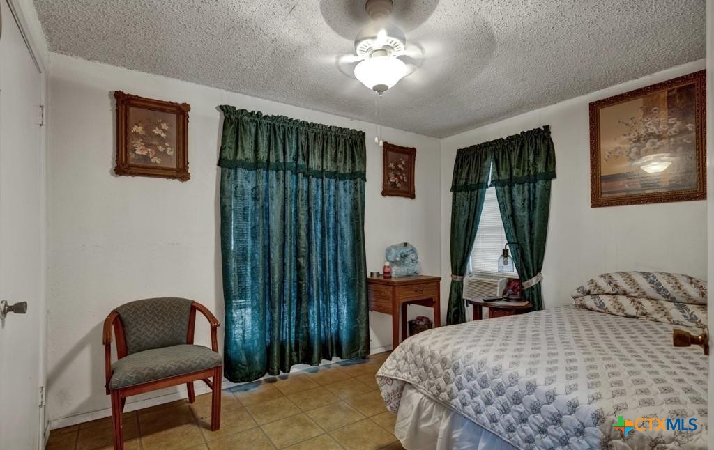 512 Valley Street San Marcos, TX 78666 - Photo 14 of 45 a bedroom with a bed and a chair