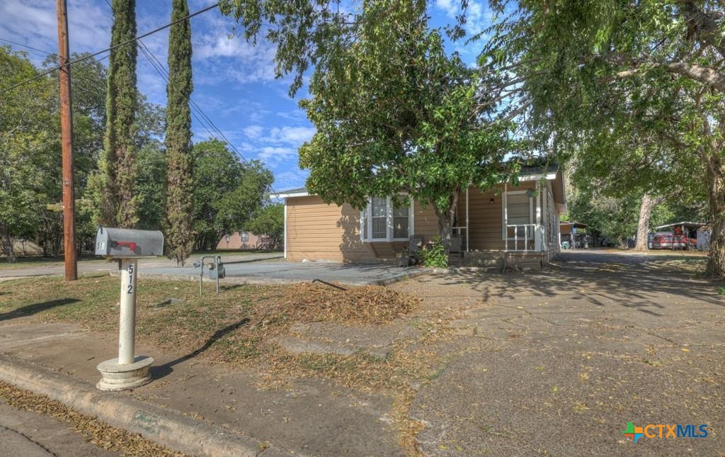 512 Valley Street San Marcos, TX 78666 - Photo 2 of 45 a backyard of a house with garden