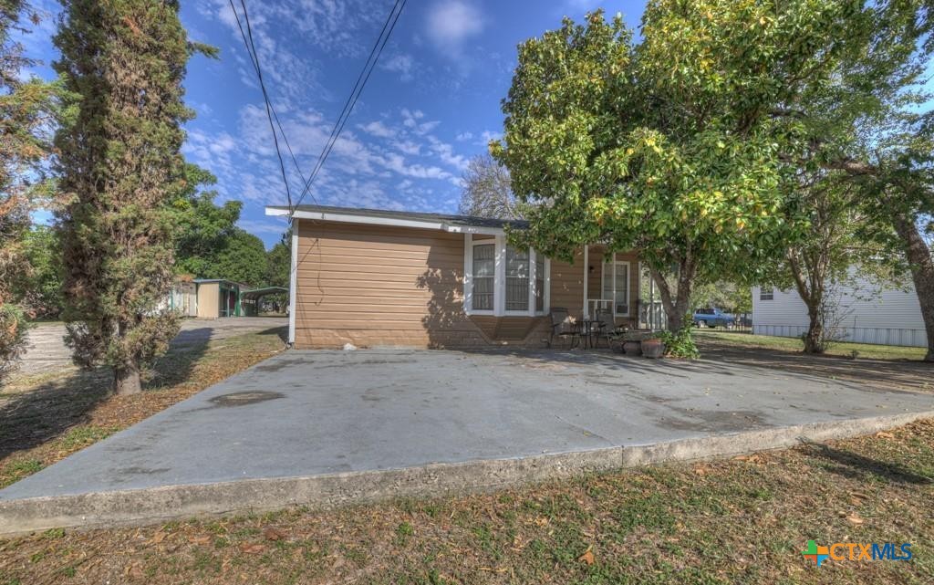 512 Valley Street San Marcos, TX 78666 - Photo 7 of 45 a view of a house with a yard and garage