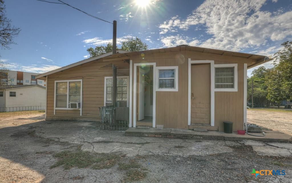 512 Valley Street San Marcos, TX 78666 - Photo 8 of 45 a view of a house with a yard and garage
