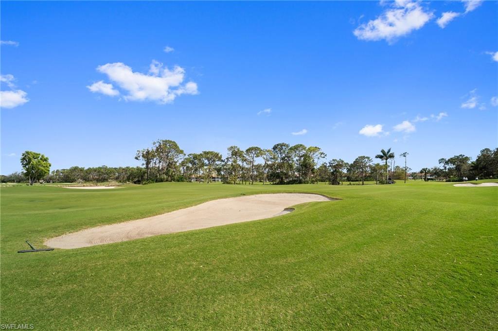 9281 Spring Run Boulevard, Unit 2607 Estero, FL 34135 - Photo 12 of 46 a view of a golf course with a lake